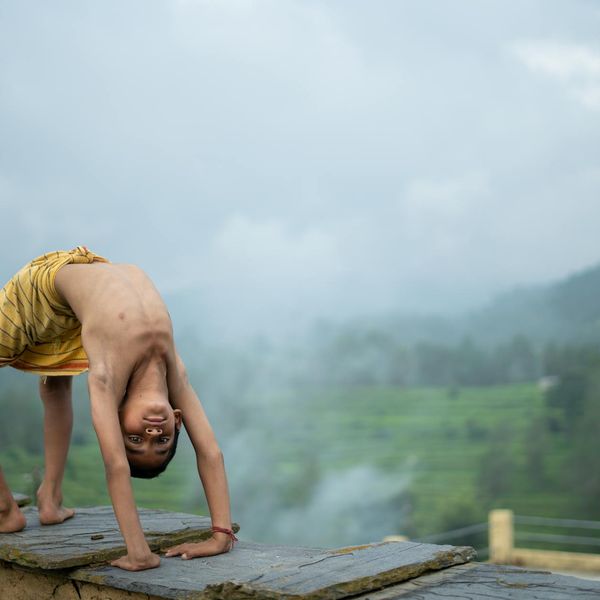 A person stretching outdoors with a serene natural background.