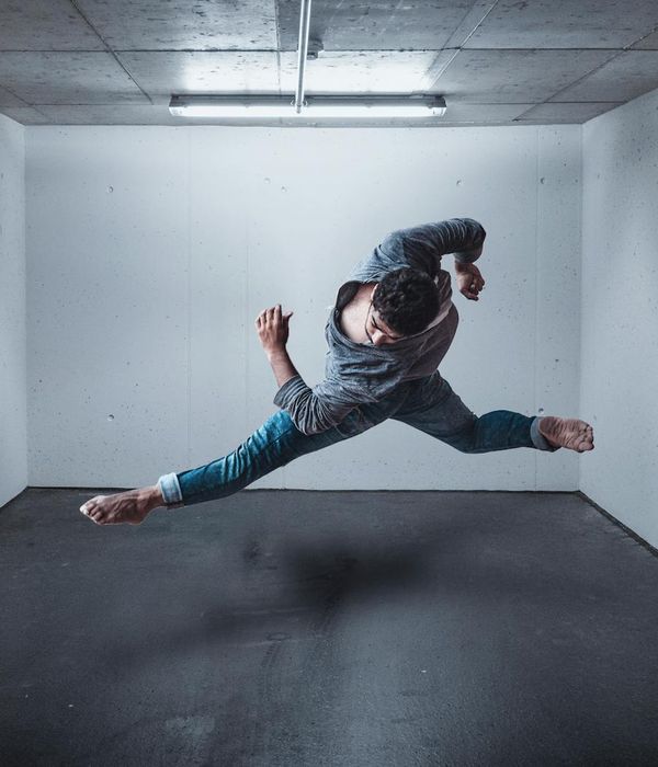 Man performing a controlled strength exercise in a bright, modern space.